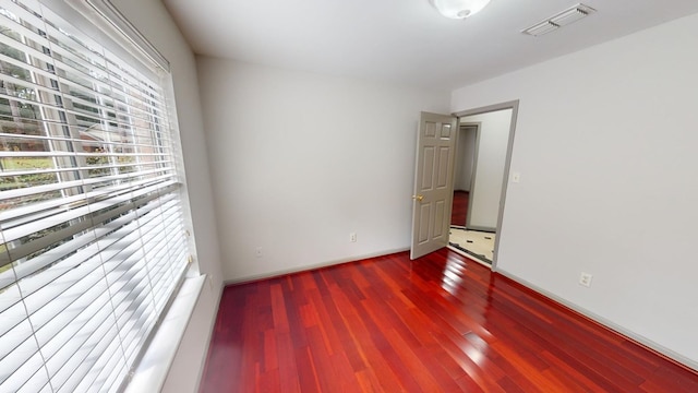 unfurnished room with wood-type flooring