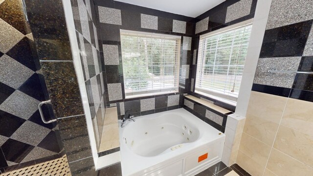 bathroom with a bath and tile walls