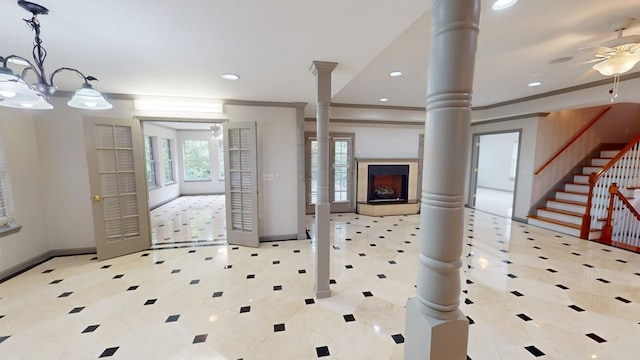 entrance foyer with crown molding, ceiling fan, and ornate columns