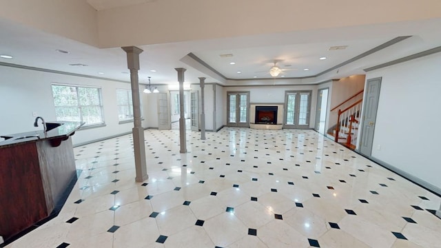 basement with crown molding, ceiling fan, and light tile patterned flooring