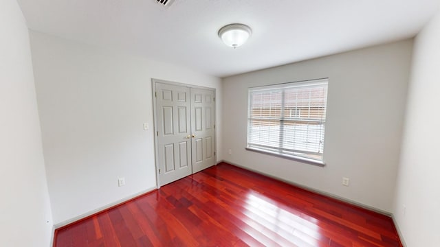 unfurnished room with dark hardwood / wood-style floors