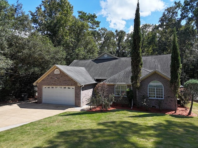 view of front of property with a garage and a front lawn