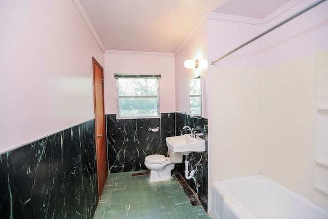 bathroom with toilet, sink, crown molding, tile walls, and a tub