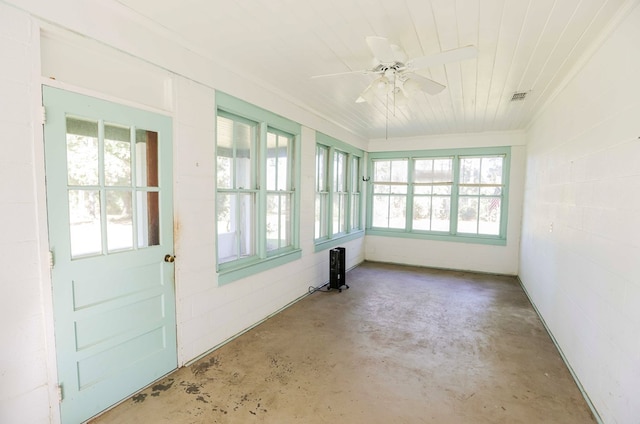 unfurnished sunroom featuring ceiling fan