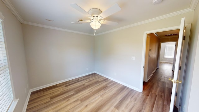 empty room featuring ornamental molding, ceiling fan, and light hardwood / wood-style flooring