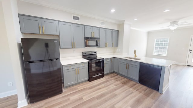 kitchen with gray cabinets, black appliances, sink, ornamental molding, and kitchen peninsula