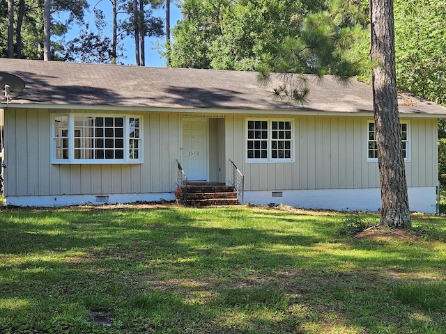 single story home with a shingled roof, entry steps, crawl space, and a front lawn