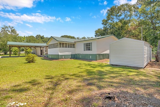 157 Quail Rdg, Moultrie, GA 31788 - rear view of house featuring a lawn and a detached carport