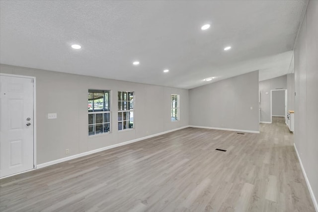 157 Quail Rdg, Moultrie, GA 31788 - unfurnished living room featuring light wood-style flooring, baseboards, recessed lighting, and a textured ceiling
