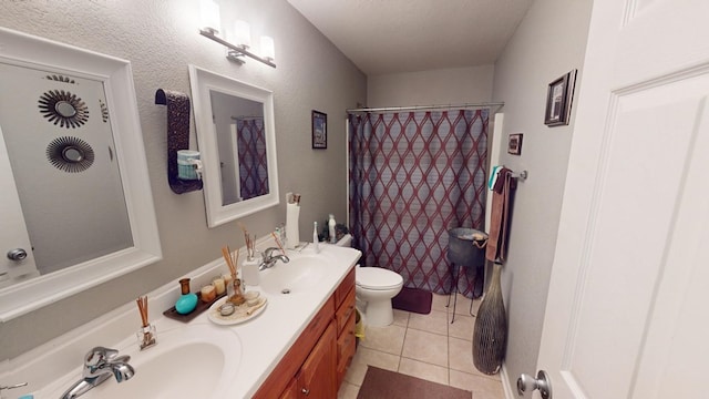 bathroom with vanity, curtained shower, tile patterned floors, and toilet