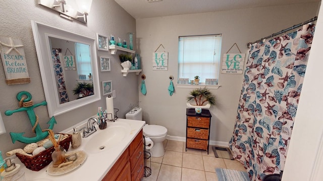 bathroom with tile patterned flooring, vanity, toilet, and walk in shower