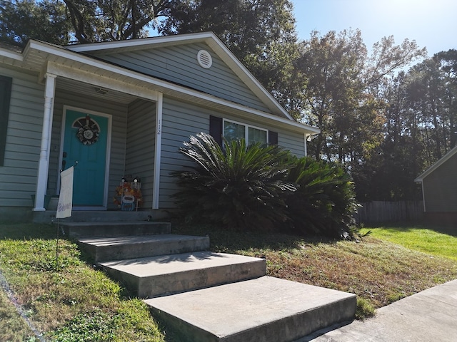 doorway to property featuring a yard