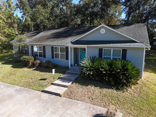 single story home featuring a front yard