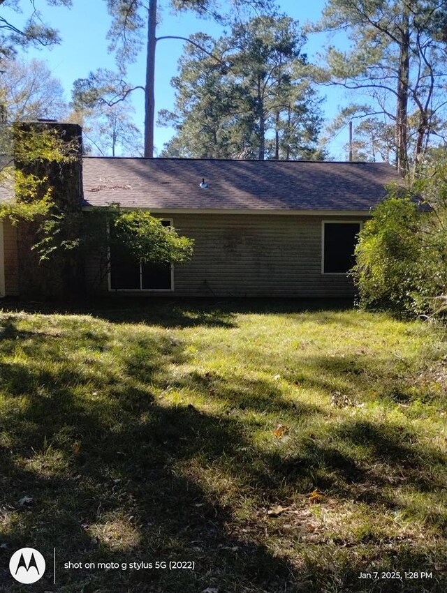 view of property exterior with a yard