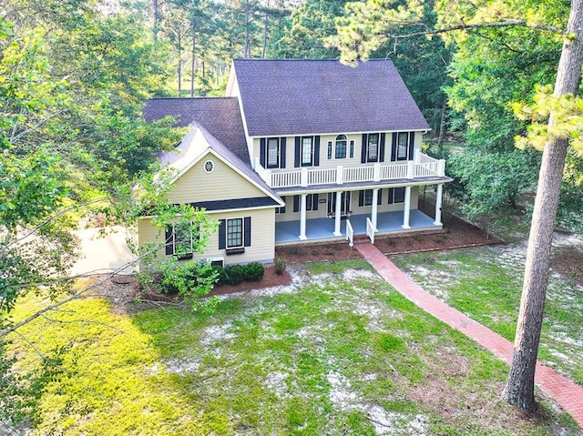 200 Sawgrass Ln, Thomasville, GA 31757 - colonial house featuring a front yard, a shingled roof, and covered porch