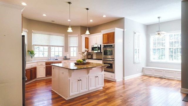 200 Sawgrass Ln, Thomasville, GA 31757 - kitchen featuring stainless steel appliances, light wood finished floors, a breakfast bar, a kitchen island, and recessed lighting