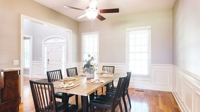 200 Sawgrass Ln, Thomasville, GA 31757 - dining space featuring a decorative wall, a ceiling fan, wainscoting, and hardwood / wood-style floors