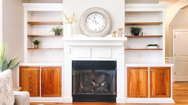 200 Sawgrass Ln, Thomasville, GA 31757 - living area with built in shelves, wood finished floors, and a glass covered fireplace