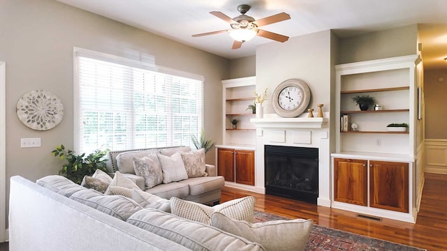 200 Sawgrass Ln, Thomasville, GA 31757 - living area featuring plenty of natural light, a ceiling fan, a fireplace, and dark wood-style floors