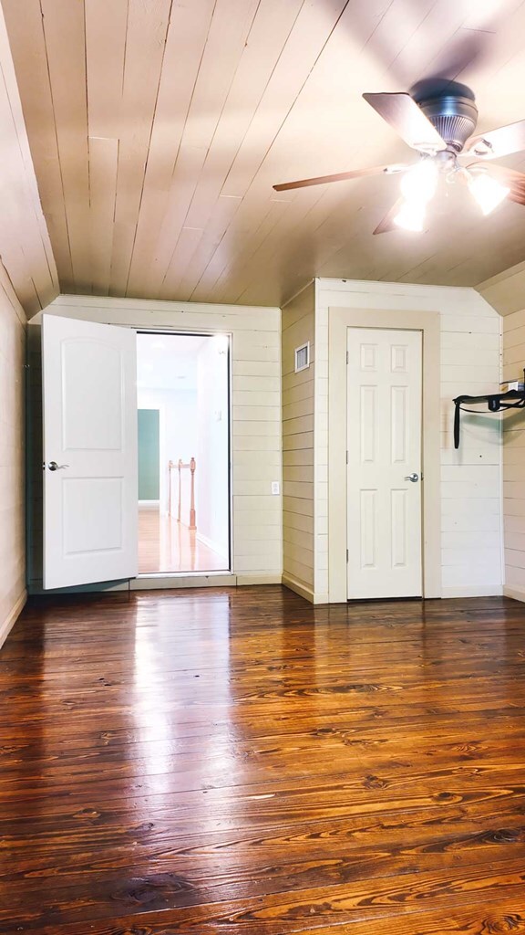 200 Sawgrass Ln, Thomasville, GA 31757 - empty room featuring vaulted ceiling, wood-type flooring, wood walls, ceiling fan, and wood ceiling
