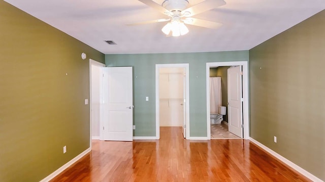 200 Sawgrass Ln, Thomasville, GA 31757 - unfurnished bedroom featuring a spacious closet, a closet, light wood-style flooring, connected bathroom, and ceiling fan