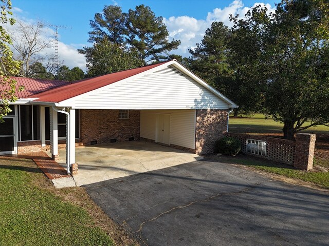 exterior space with a carport