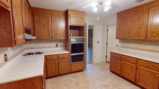 kitchen with wall oven, backsplash, exhaust hood, and white electric stovetop