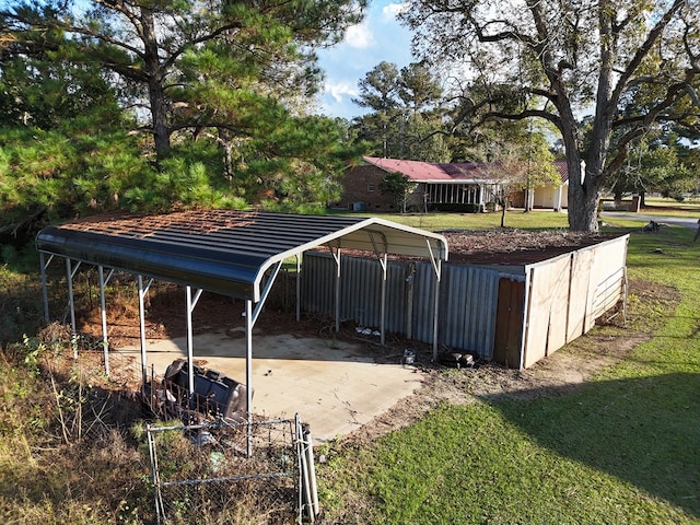 view of swimming pool featuring a carport and a yard