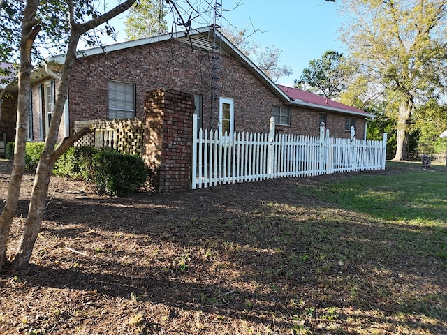 view of side of property with a yard