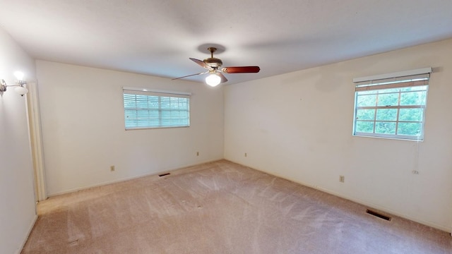 unfurnished room with light carpet and ceiling fan