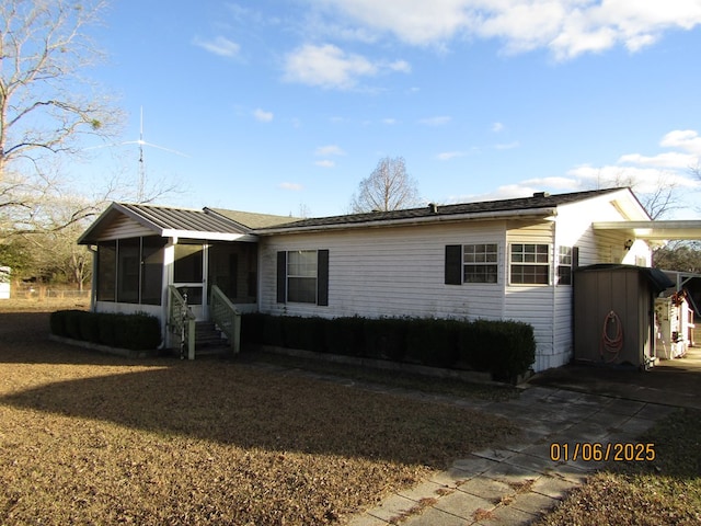 view of front of home featuring a sunroom