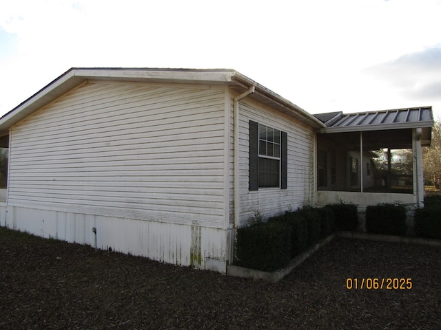 view of home's exterior with a sunroom