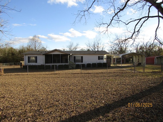 rear view of property featuring a carport