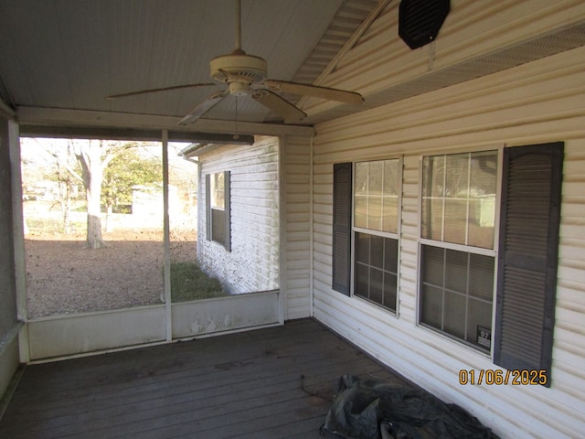 unfurnished sunroom featuring ceiling fan