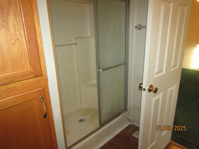 bathroom with a shower with shower door