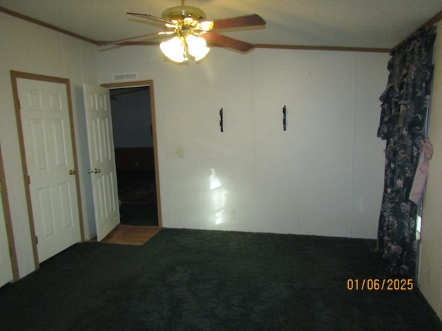 unfurnished room with crown molding, carpet floors, and ceiling fan