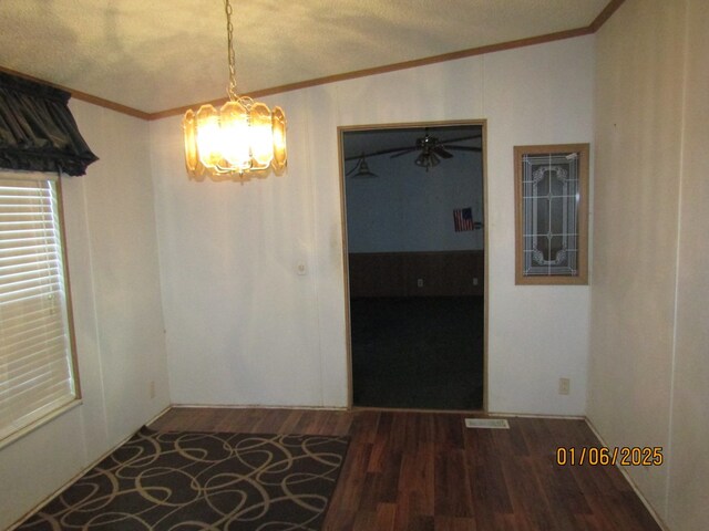 unfurnished dining area with crown molding, dark hardwood / wood-style flooring, and a chandelier