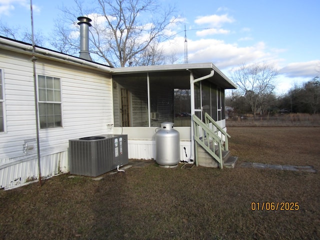 exterior space featuring cooling unit and a sunroom