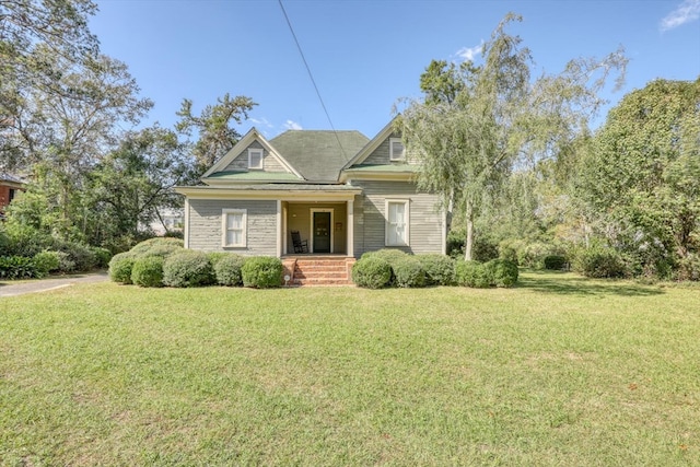 view of front of property with a front yard and covered porch