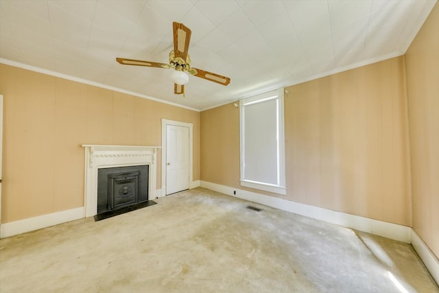 unfurnished living room featuring crown molding, carpet floors, and ceiling fan