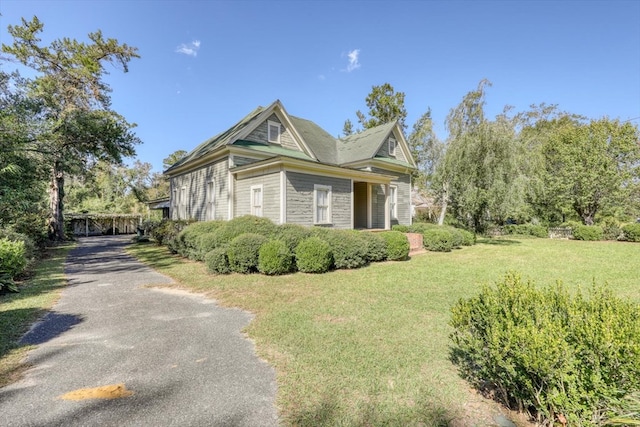 view of side of property with a lawn