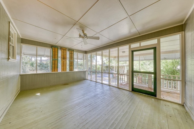 unfurnished sunroom with ceiling fan