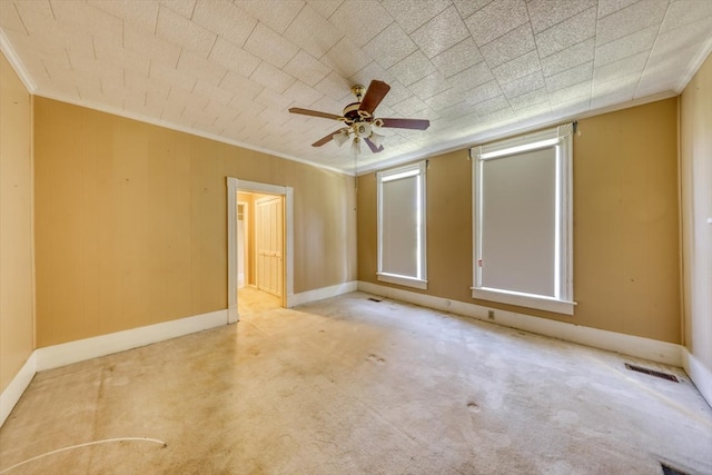 empty room with light carpet, crown molding, and ceiling fan