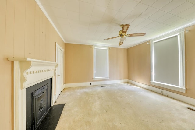 unfurnished living room with crown molding, carpet floors, and ceiling fan