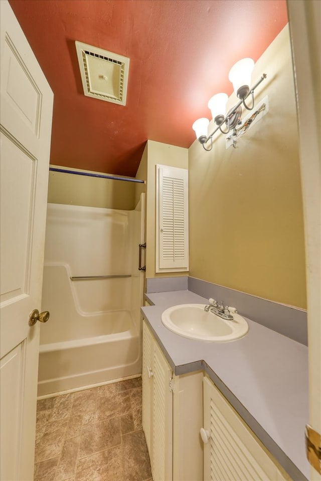 bathroom with vanity, shower / bathing tub combination, and a chandelier