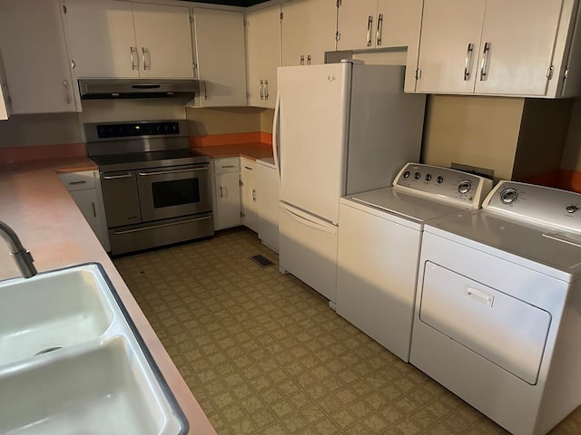 kitchen featuring white cabinetry, double oven range, independent washer and dryer, and white fridge