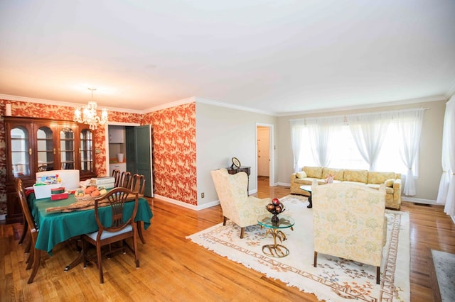 dining room with crown molding, a chandelier, and light wood-type flooring