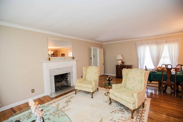 living room featuring hardwood / wood-style floors, a notable chandelier, ornamental molding, and a premium fireplace