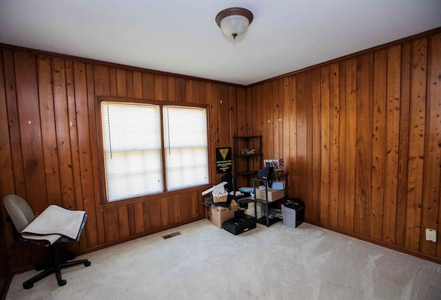 office area with light colored carpet and wood walls