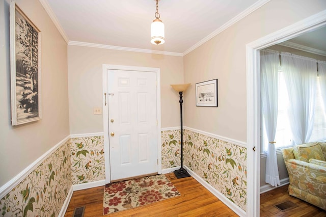 foyer with wood-type flooring and ornamental molding